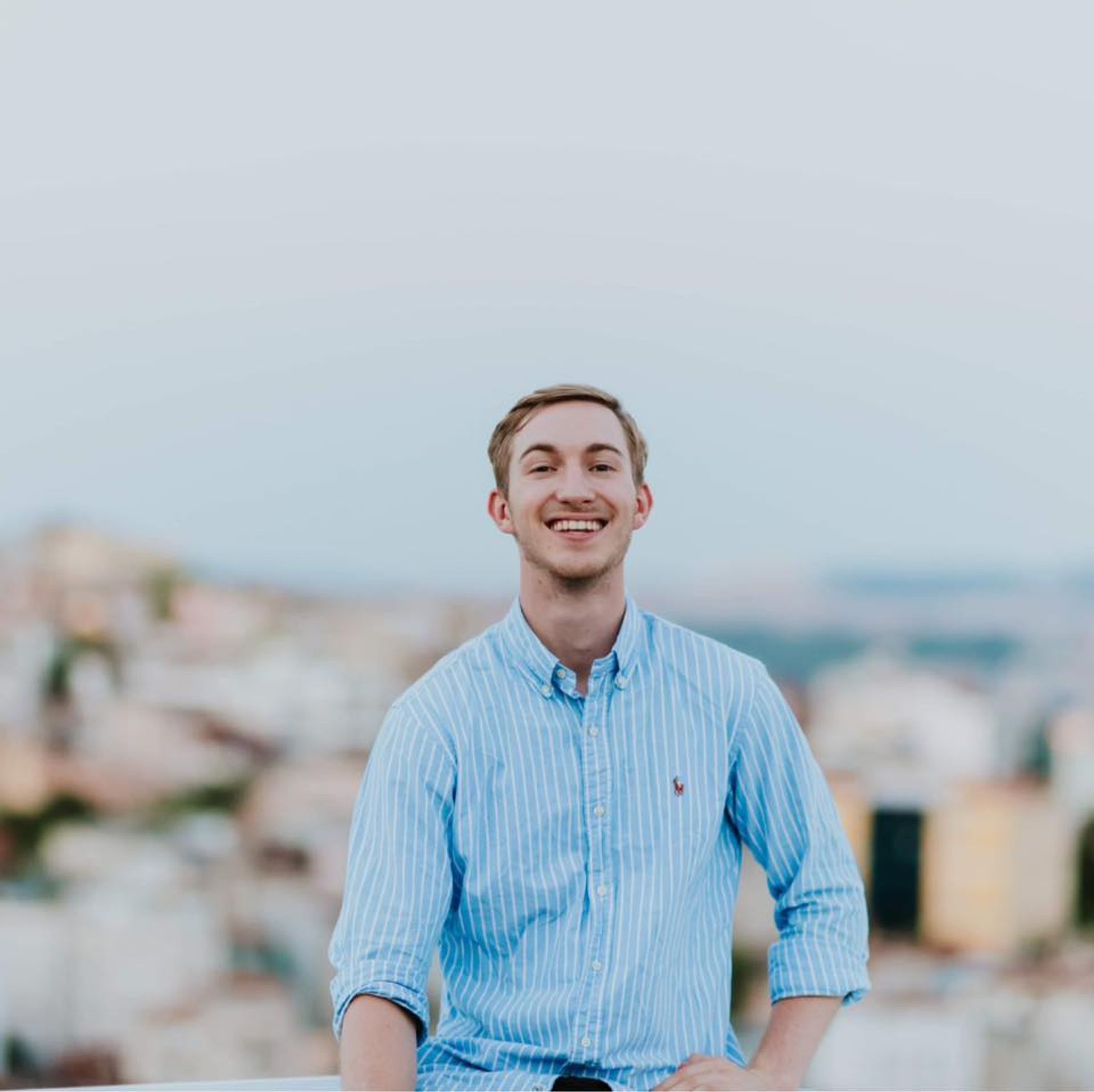 Mountains and houses, person standing in front of them